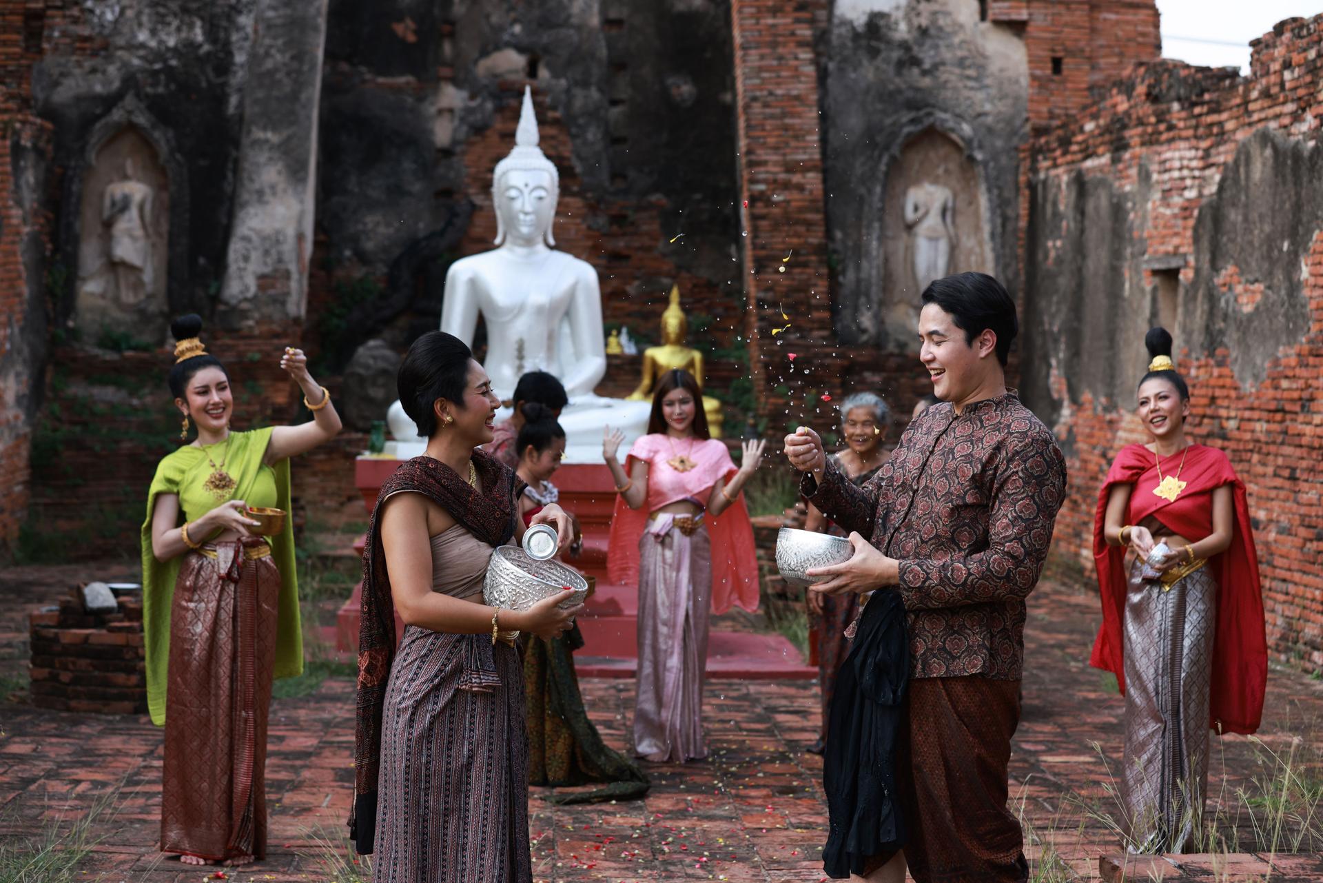 Asia people gathering at temple are splashing water together, Songkran festival culture and lifestyle